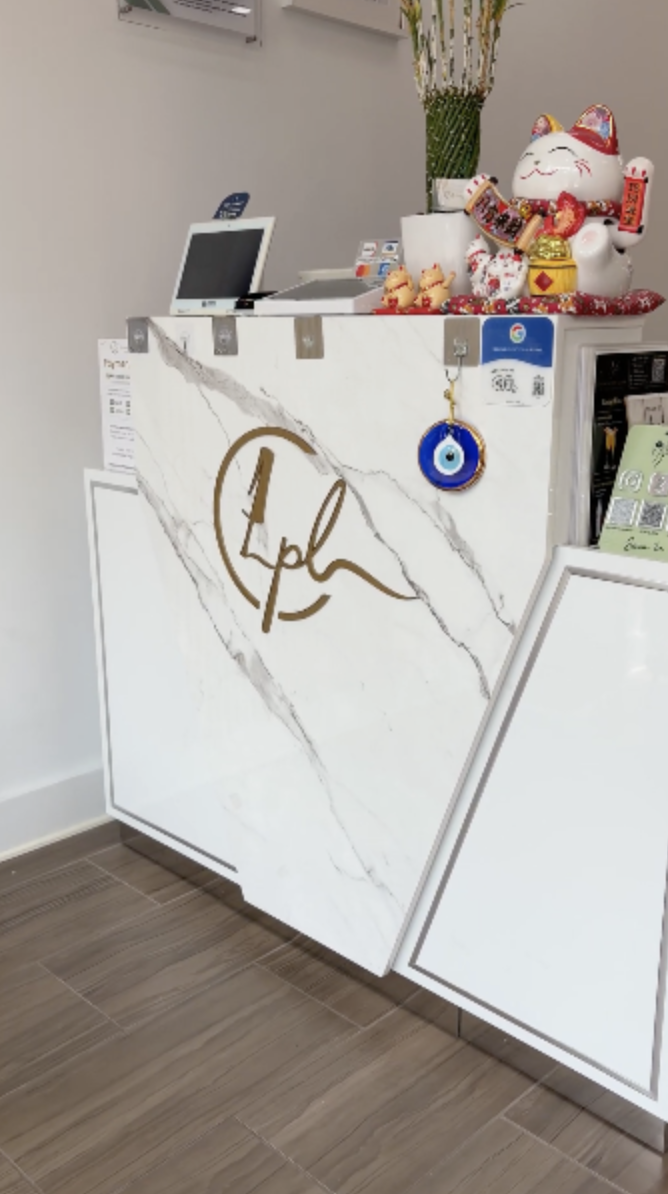 Marble reception desk with the Constance Polish Lounge gold logo