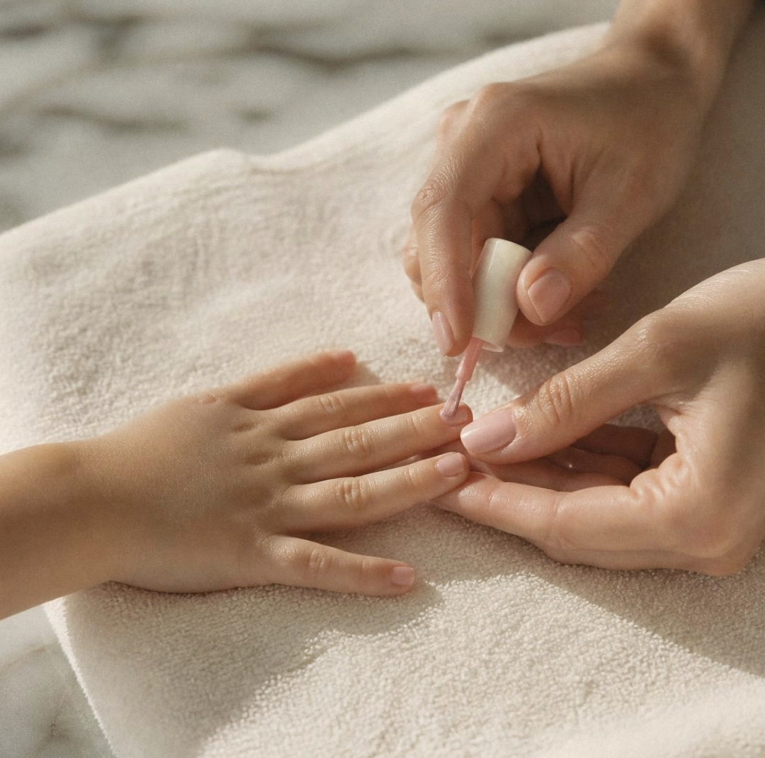 Gentle nail polish application on a child's hand