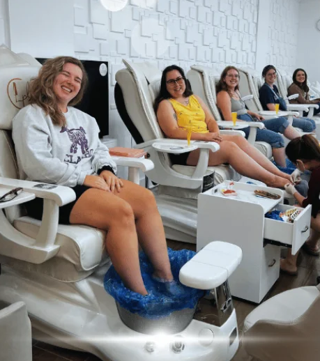 Guests relaxing in spa pedicure chairs at Constance Polish Lounge in Fairfax